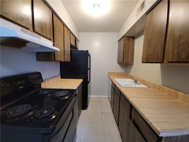 kitchen featuring sink, light tile patterned floors, and black appliances