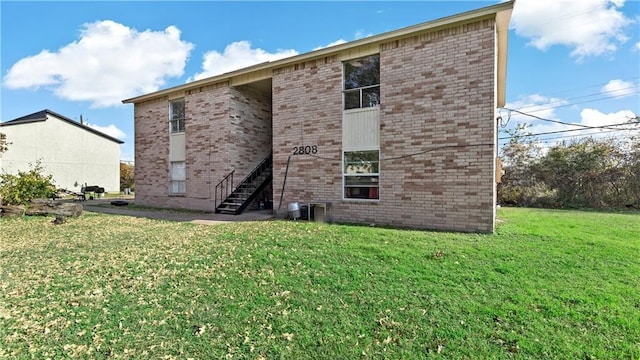 rear view of property with a yard