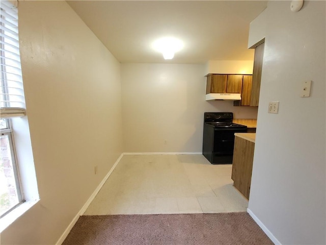 kitchen featuring light colored carpet and black / electric stove