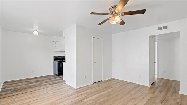 unfurnished living room featuring ceiling fan and light hardwood / wood-style floors