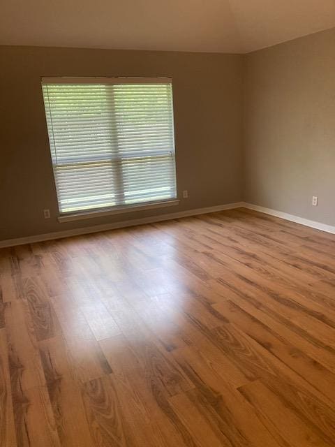 2704 Barronwood Dr, Bryan, TX 77807 - unfurnished room featuring wood finished floors and baseboards