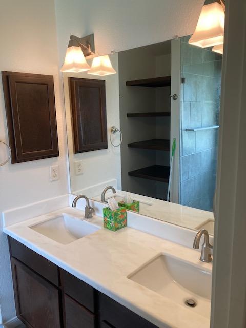 2704 Barronwood Dr, Bryan, TX 77807 - bathroom with double vanity and tiled shower