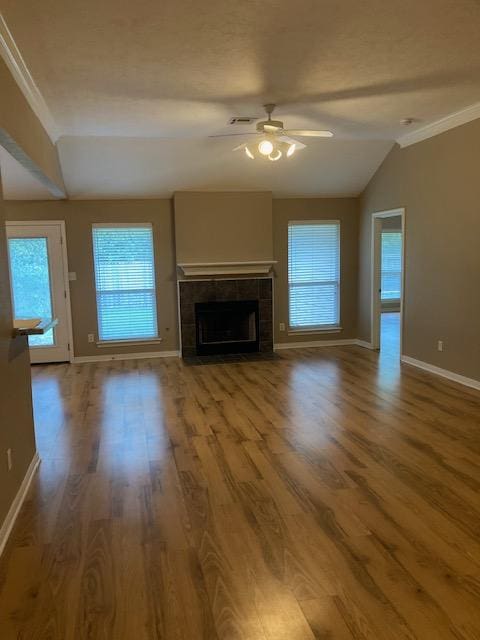 2704 Barronwood Dr, Bryan, TX 77807 - unfurnished living room with ceiling fan, baseboards, ornamental molding, healthy amount of natural light, and wood finished floors