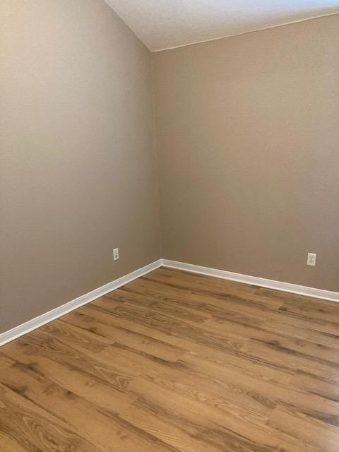 2704 Barronwood Dr, Bryan, TX 77807 - unfurnished room featuring light wood-style floors, lofted ceiling, and baseboards