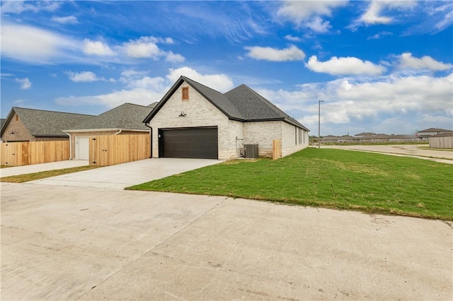 881 Double Mountain Rd, College Station, TX 77845 - view of front of home featuring concrete driveway, cooling unit, roof with shingles, and a garage