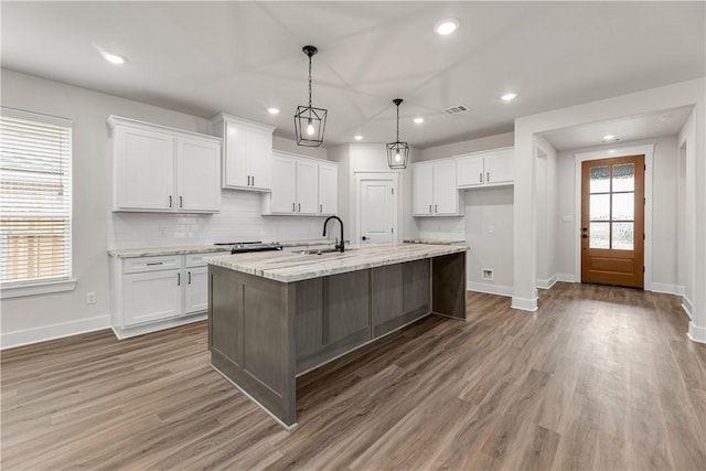 881 Double Mountain Rd, College Station, TX 77845 - kitchen with a sink, baseboards, white cabinetry, and recessed lighting