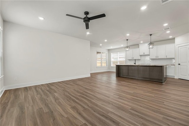 881 Double Mountain Rd, College Station, TX 77845 - unfurnished living room featuring ceiling fan, dark wood-style flooring, recessed lighting, and baseboards