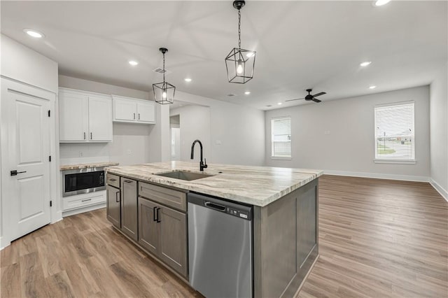 881 Double Mountain Rd, College Station, TX 77845 - kitchen featuring dishwasher, a sink, built in microwave, recessed lighting, and white cabinetry