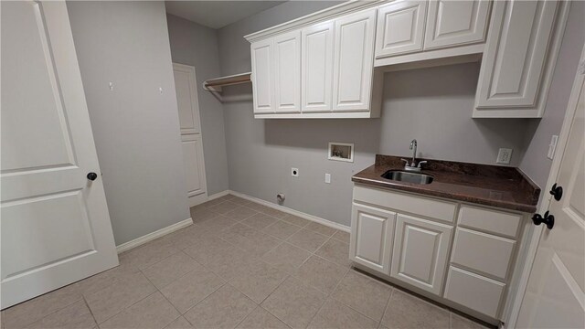 laundry room with hookup for a washing machine, electric dryer hookup, cabinet space, baseboards, and light tile patterned flooring