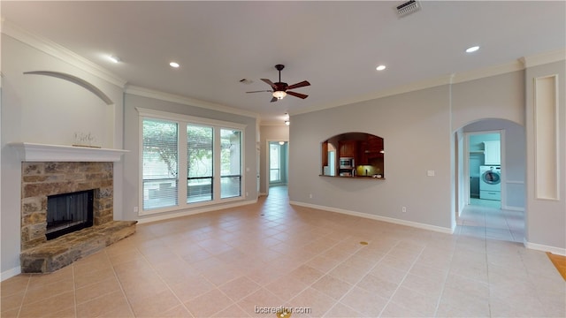 unfurnished living room with ceiling fan, a fireplace, crown molding, and washer / clothes dryer