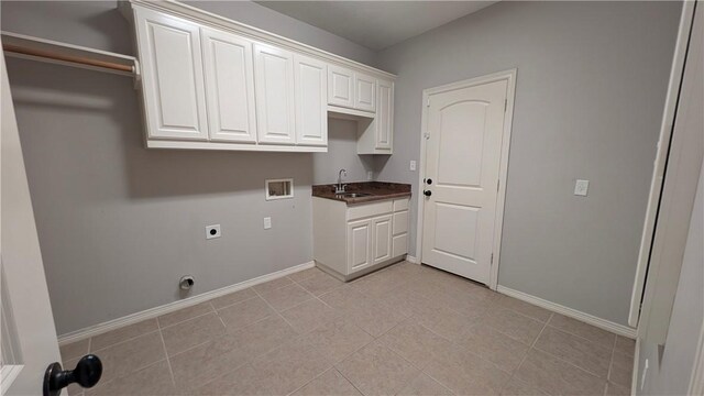 laundry room featuring hookup for a washing machine, cabinet space, hookup for an electric dryer, and baseboards
