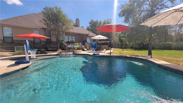 view of pool with a patio area and a yard