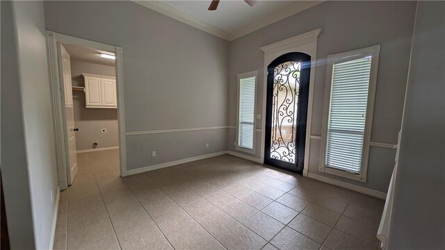 unfurnished living room featuring a fireplace, ornamental molding, light tile patterned floors, ceiling fan, and a chandelier