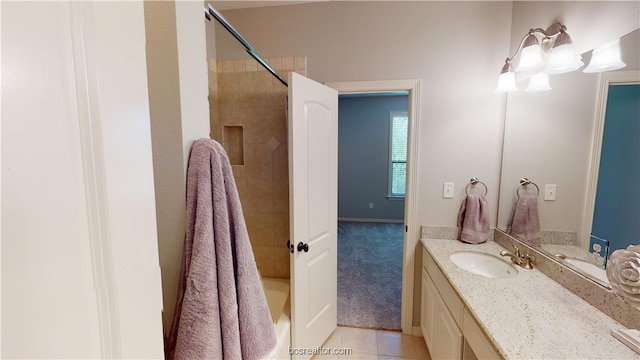 bathroom with vanity, tile patterned floors, and tiled shower / bath