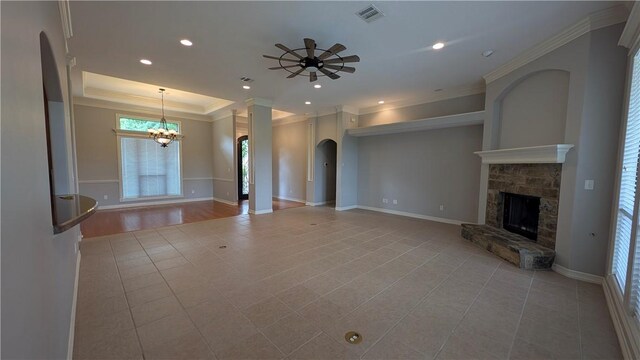 kitchen with a sink, arched walkways, appliances with stainless steel finishes, a center island, and brown cabinetry