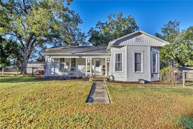 view of front of property with covered porch and a front yard