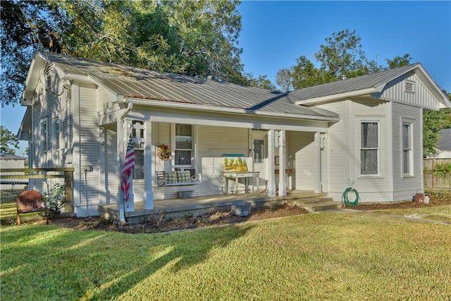 bungalow featuring a front lawn and a porch