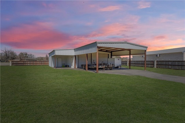 1796 Fawn Lake Dr, Bryan, TX 77808 - back of house at dusk featuring a garage