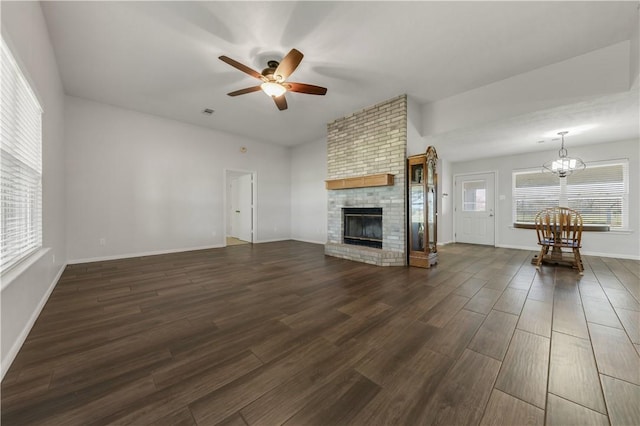 1796 Fawn Lake Dr, Bryan, TX 77808 - living area with a chandelier, a ceiling fan, dark wood-style floors, a fireplace, and baseboards