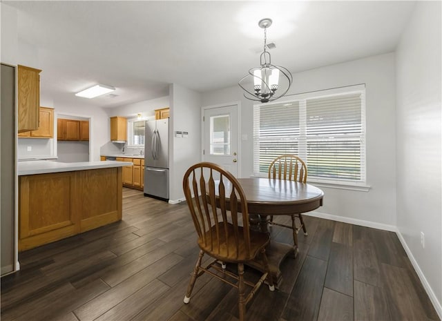 dining room featuring a wealth of natural light, baseboards, and dark wood-style floors