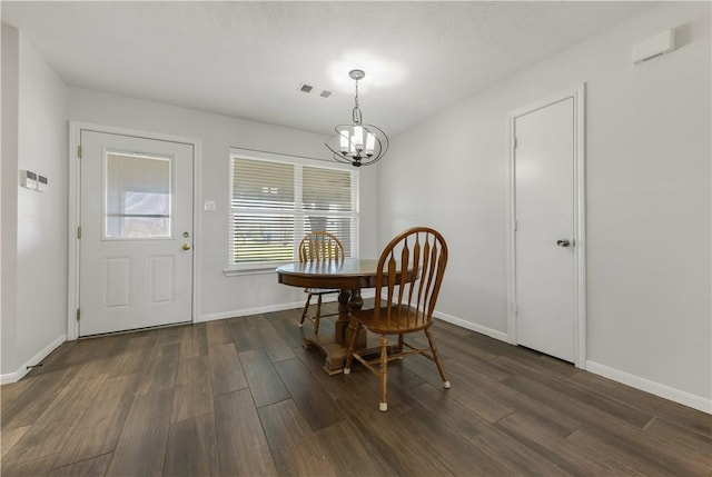 dining room with visible vents, baseboards, dark wood finished floors, and a chandelier