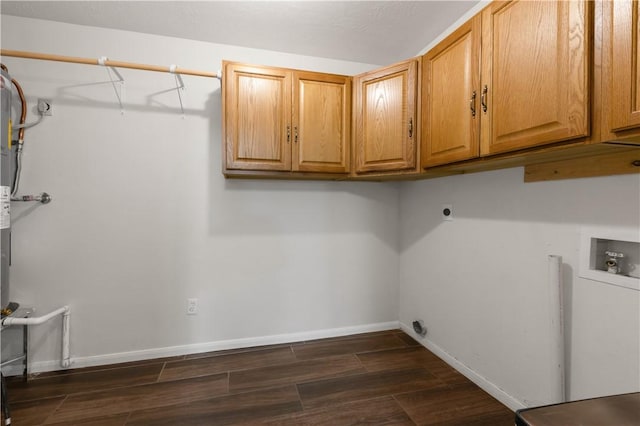 laundry area with baseboards, hookup for an electric dryer, cabinet space, washer hookup, and dark wood-type flooring