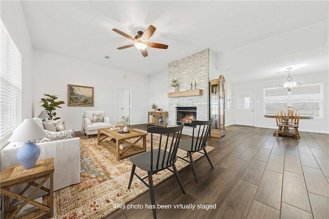 1796 Fawn Lake Dr, Bryan, TX 77808 - living area featuring wood finished floors, a ceiling fan, a chandelier, a brick fireplace, and baseboards