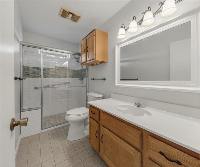 full bath with tile patterned floors, visible vents, toilet, a stall shower, and vanity