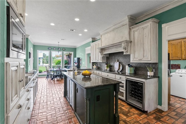 17265 Fm 2154th Rd, College Station, TX 77845 - kitchen with washer / clothes dryer, beverage cooler, brick flooring, stainless steel microwave, and recessed lighting