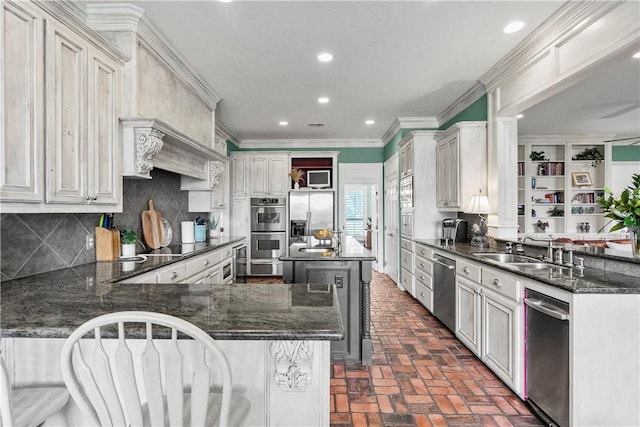 17265 Fm 2154th Rd, College Station, TX 77845 - kitchen with a sink, brick floors, stainless steel appliances, a peninsula, and tasteful backsplash