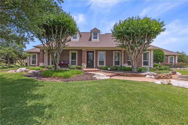 17265 Fm 2154th Rd, College Station, TX 77845 - cape cod house featuring a front yard and brick siding