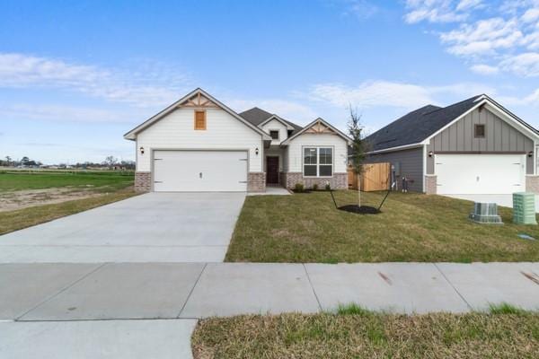 modern farmhouse style home featuring a garage, a front yard, brick siding, board and batten siding, and driveway