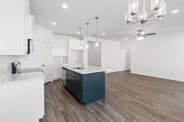 kitchen with a sink, ceiling fan with notable chandelier, range, and white cabinets