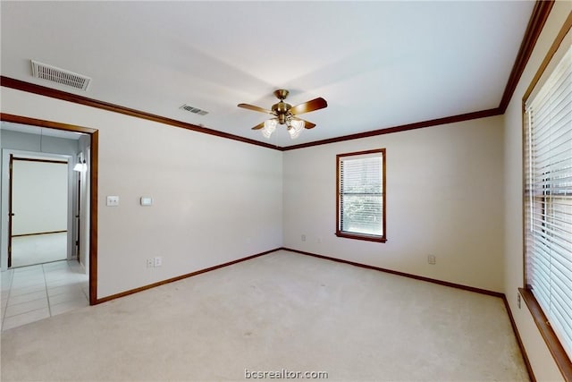 unfurnished room featuring ceiling fan, light colored carpet, and ornamental molding