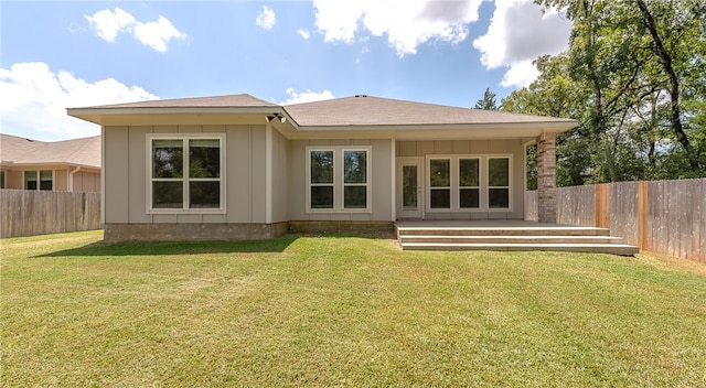 back of house with a lawn