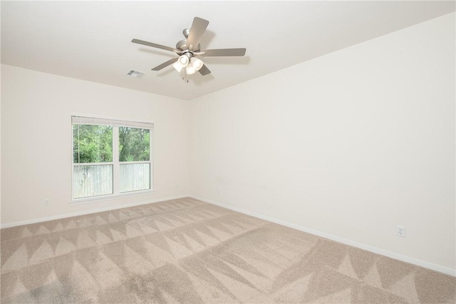 unfurnished room with ceiling fan and light carpet