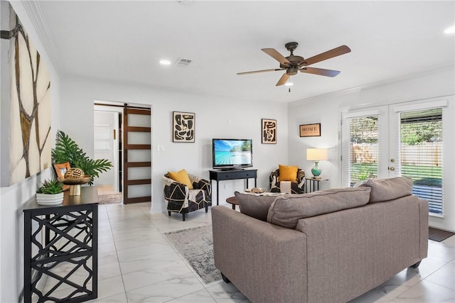 living room featuring french doors, a barn door, ceiling fan, and ornamental molding