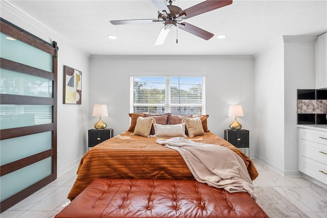 bedroom featuring ceiling fan, a barn door, and crown molding