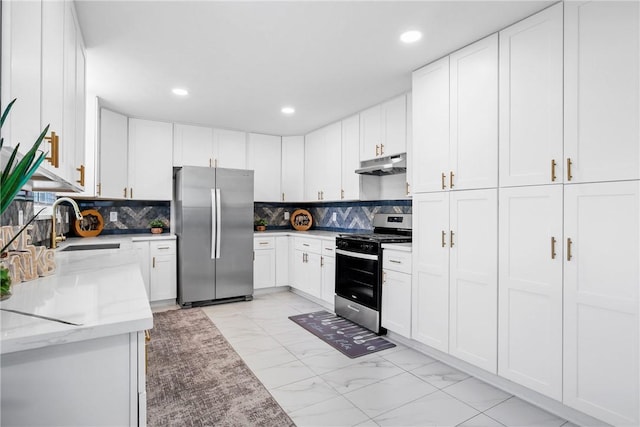 kitchen with light stone countertops, sink, decorative backsplash, white cabinets, and appliances with stainless steel finishes