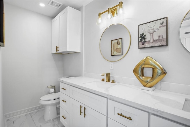 bathroom featuring vanity and toilet