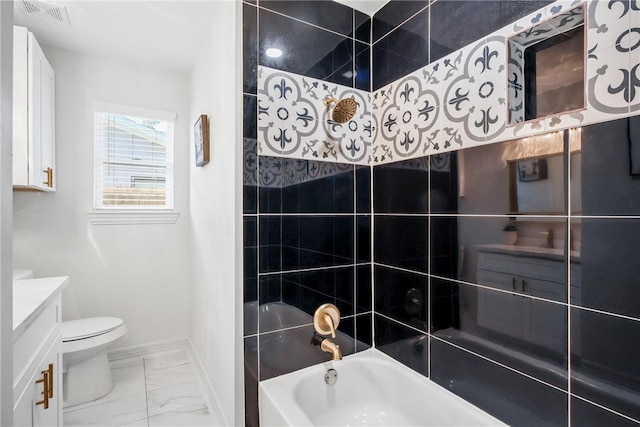 full bathroom featuring vanity, toilet, and tiled shower / bath