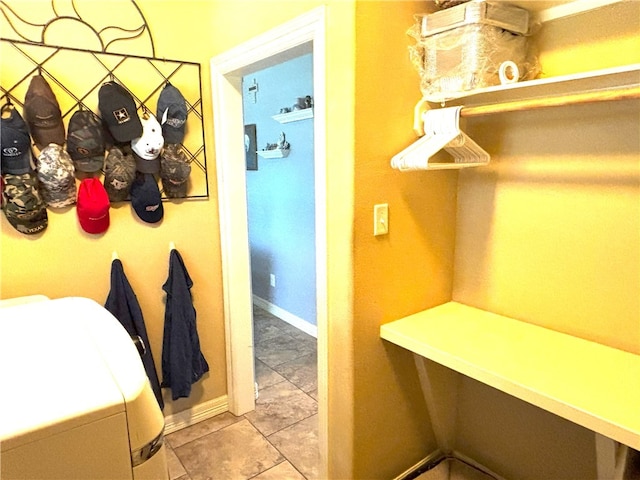 7585 Field Creek Estates Dr, Bryan, TX 77808 - washroom with tile patterned floors, washer / dryer, and baseboards