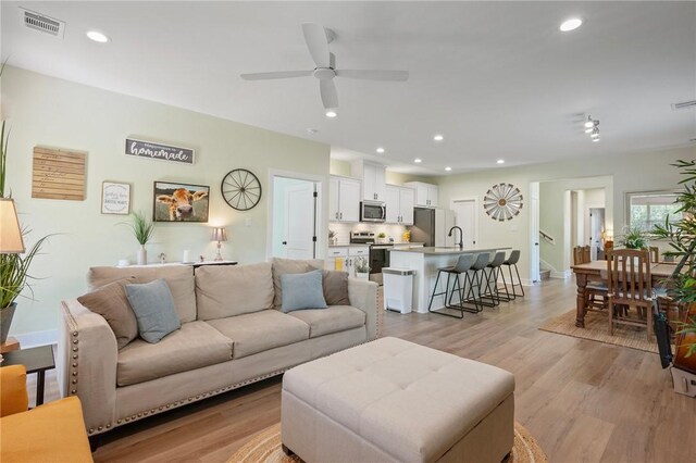 3914 Alamosa St, College Station, TX 77845 - living area with light wood-style floors, a ceiling fan, recessed lighting, and baseboards