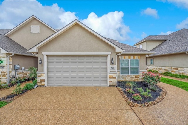 1749 Dakota Ln, College Station, TX 77845 - view of front facade with stone siding, stucco siding, a garage, and driveway