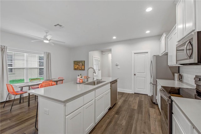 1749 Dakota Ln, College Station, TX 77845 - kitchen featuring stainless steel appliances, a sink, a kitchen island with sink, white cabinetry, and a ceiling fan