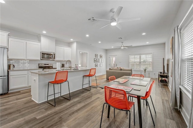 1749 Dakota Ln, College Station, TX 77845 - dining room featuring a ceiling fan, wood finished floors, recessed lighting, and baseboards