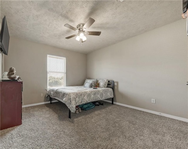 carpeted bedroom with ceiling fan and a textured ceiling