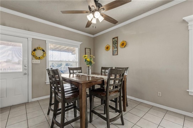 dining area featuring ceiling fan, light tile patterned flooring, and ornamental molding