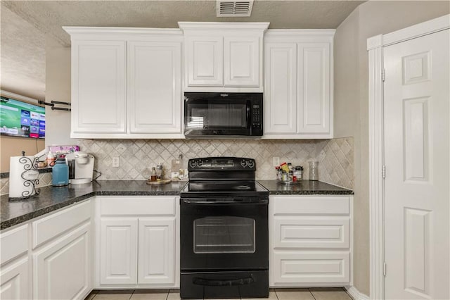 kitchen featuring black appliances, decorative backsplash, white cabinetry, and light tile patterned floors