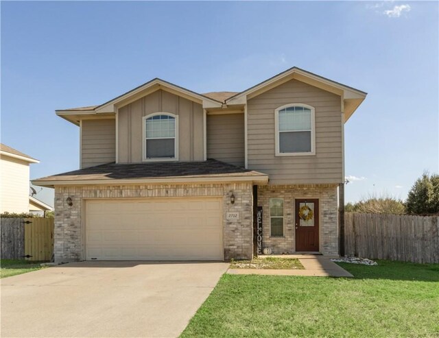 view of front facade featuring a garage and a front lawn